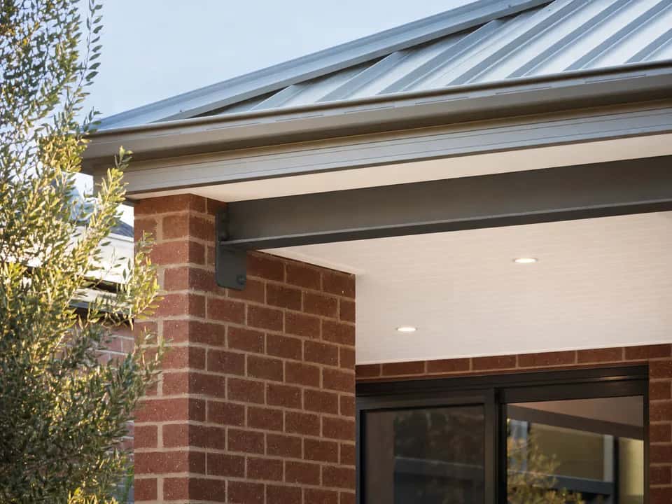 Alfresco beam fixed into the brick wall under the main roofline, lined ceiling above
