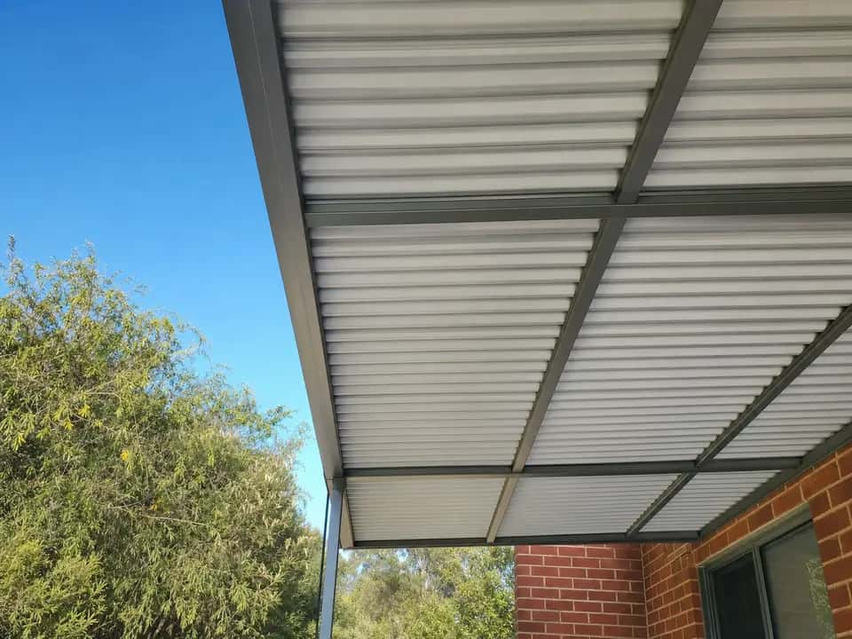 Corrugated steel roof sheets under a flat roof patio
